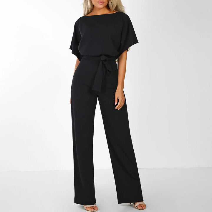 Grace black tie-waist wide-leg jumpsuit with draped short sleeves for polished ease.