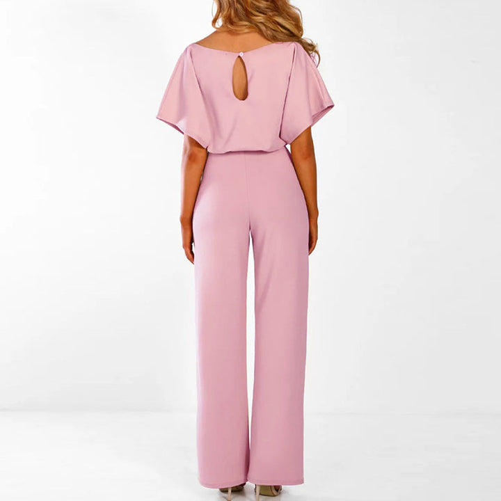 Grace women's tie-waist wide-leg jumpsuit in blush pink, featuring draped short sleeves and a keyhole back.