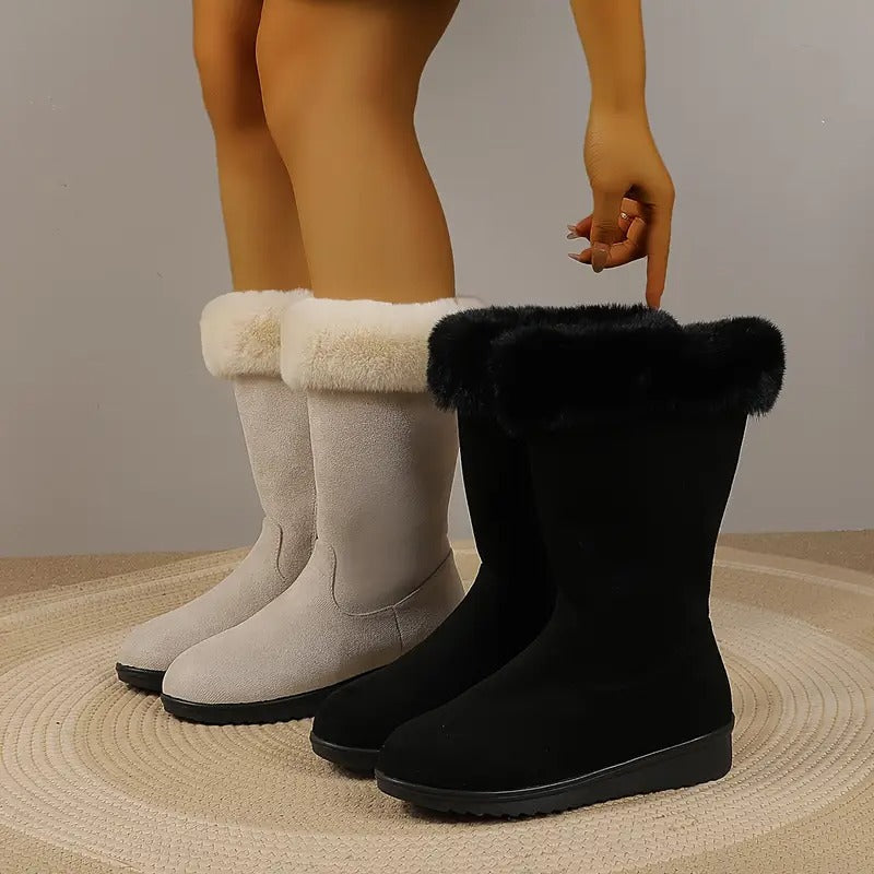 Beige and black mid-calf winter boots featuring plush faux fur cuffs and soft suede-like material.