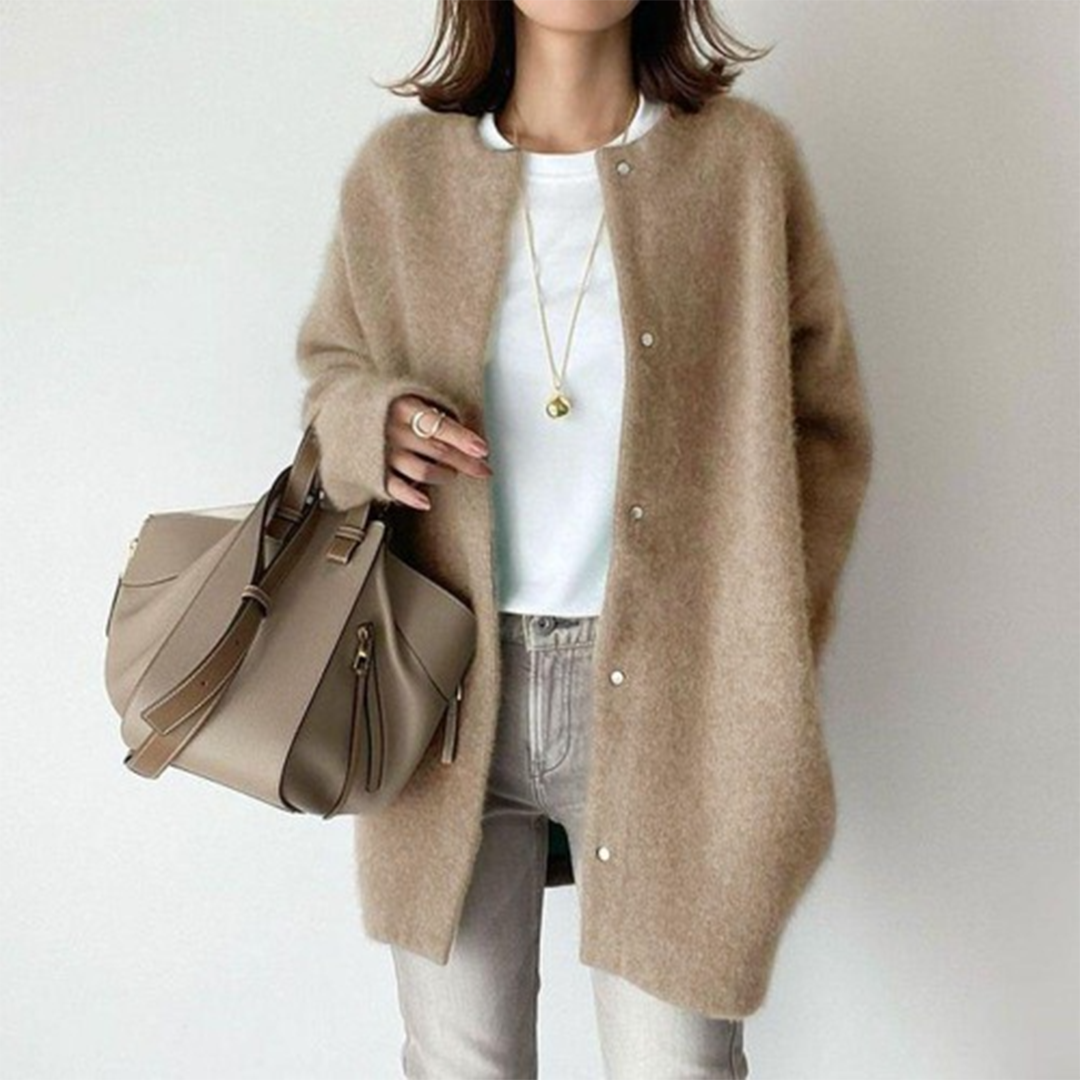 Oversized beige longline cardigan in soft brushed knit with a collarless round neckline and button-front closure.