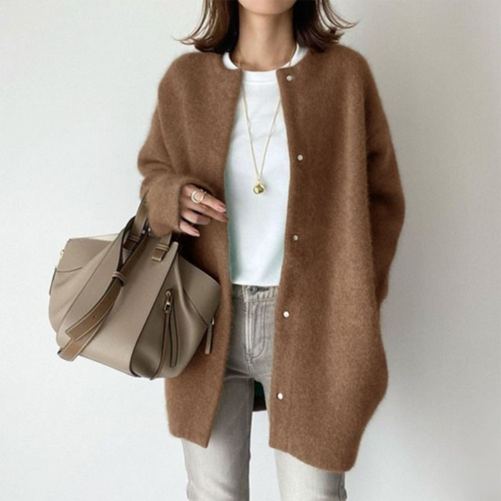 Soft brown oversized longline cardigan with a collarless round neckline and button-front closure in a cozy brushed knit.