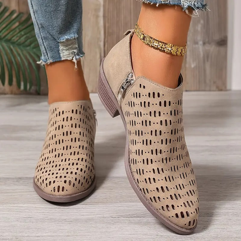 Beige Harriet ankle boots with a modern cut-out design, side zip, and comfortable low block heel for effortless spring styling.