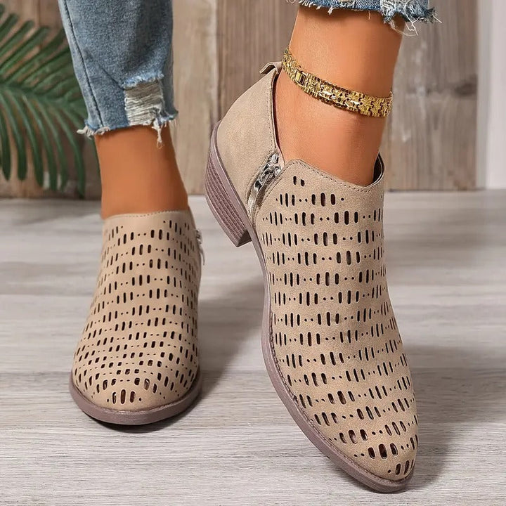 Beige Harriet ankle boots with a modern cut-out design, side zip, and comfortable low block heel for effortless spring styling.