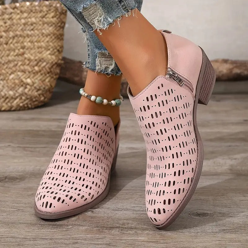 Light pink Harriet ankle boots featuring a breathable cut-out design, side zip closure, and a comfortable low block heel.