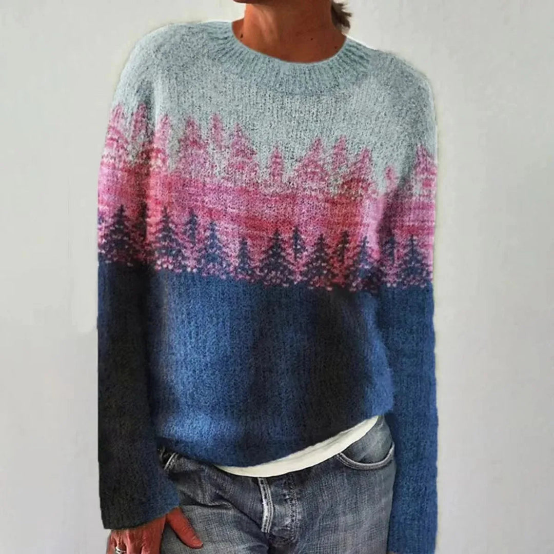 Women's soft knit jumper featuring a blue and pink Nordic forest landscape pattern with a relaxed fit and crew neckline.