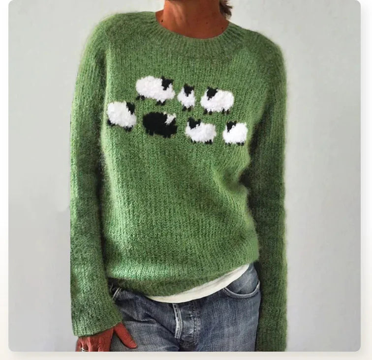 Green fuzzy knit jumper featuring a playful white and black sheep pattern with a relaxed fit and crew neckline.