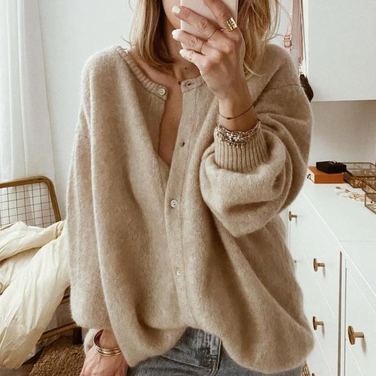 Oversized beige fluffy knit cardigan with a button-front, round neckline, and ribbed cuffs for a cozy, relaxed fit.