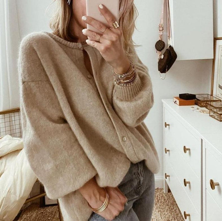 Oversized beige fluffy knit cardigan with a button front, round neckline, and ribbed cuffs for a cozy, relaxed fit.