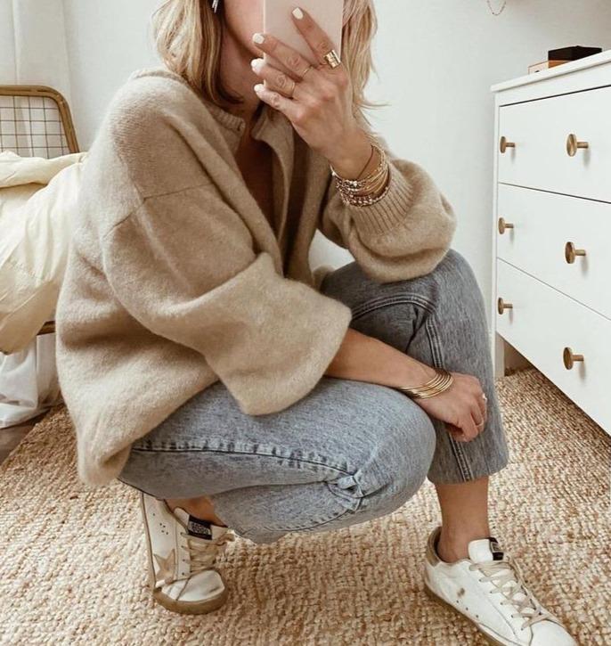 Oversized beige fluffy knit cardigan with a button front, round neckline, and ribbed cuffs for a cozy, relaxed fit.