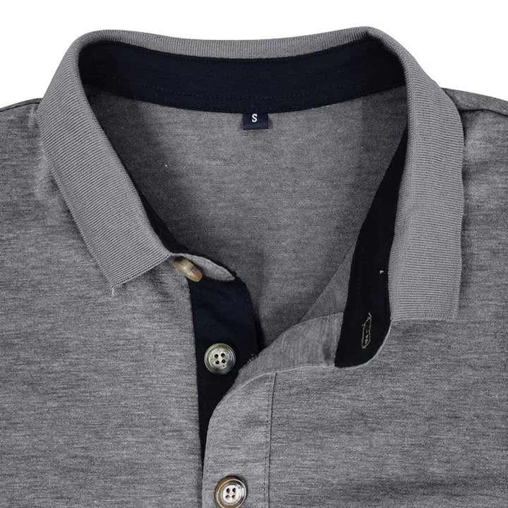 Grey long-sleeve polo shirt with a contrasting navy collar, two-button placket, and size small label.