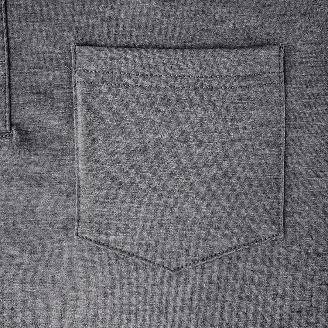 Close-up of a charcoal grey Harry long sleeve polo shirt featuring a neat chest pocket with detailed stitching.