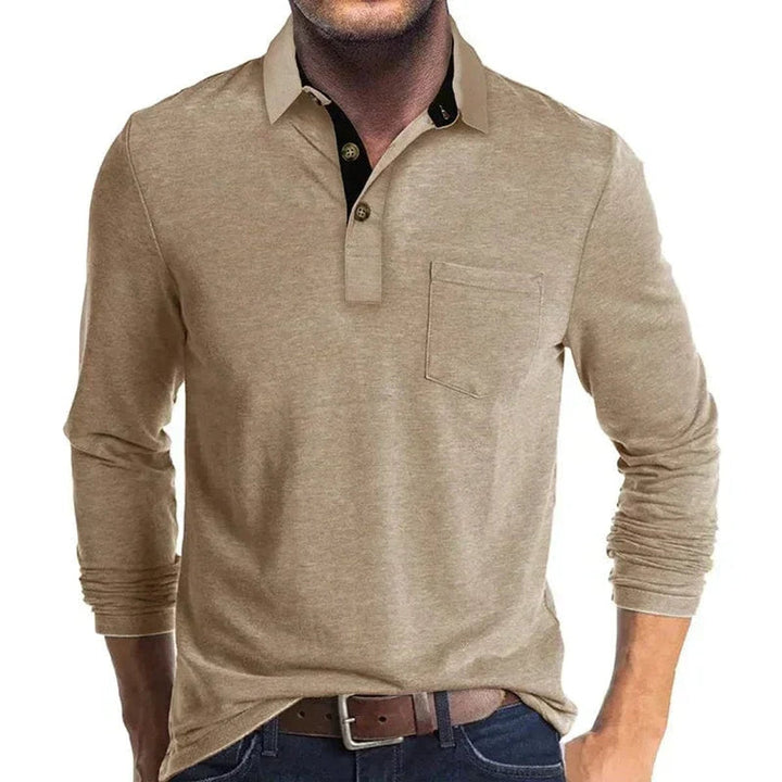 Tan long-sleeve polo shirt with a black contrast collar, two-button placket, and a functional chest pocket.