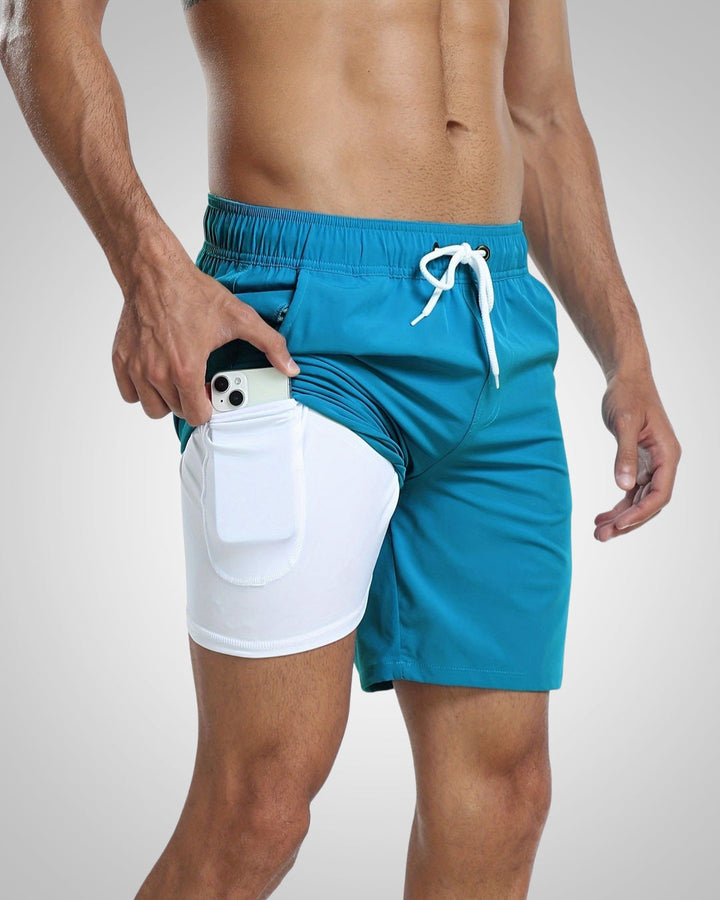 Teal men's lined swim shorts with a white drawstring waist and a built-in white inner short featuring a side phone pocket.