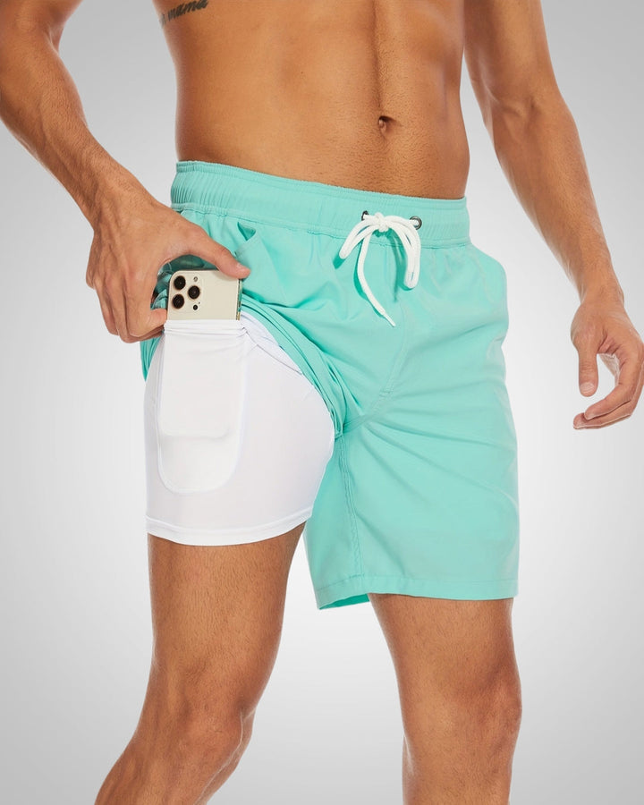 Mint green men's swim shorts with a white inner liner and side phone pocket, featuring an adjustable drawstring waist.