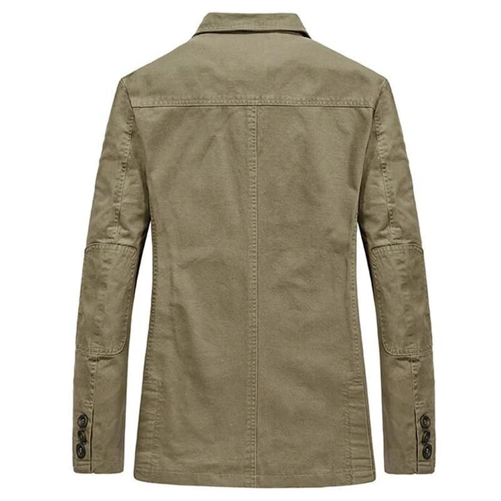 Back view of a khaki cotton casual blazer featuring elbow patches and buttoned cuffs in a relaxed, workwear-inspired style.