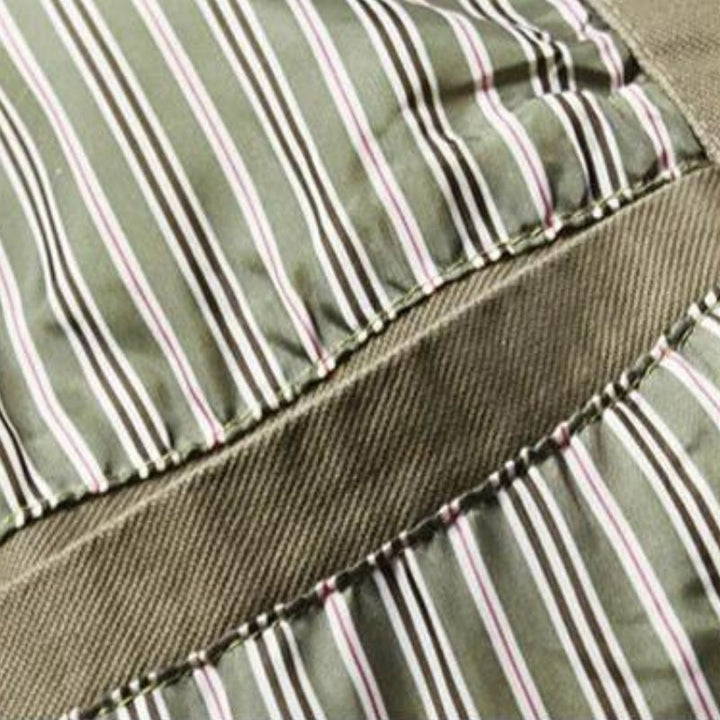 Close-up of olive green cotton blazer featuring a striped inner lining and durable fabric texture.