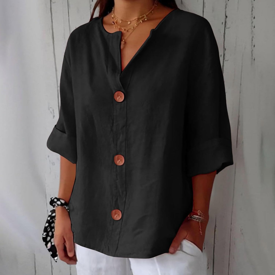 Black linen V-neck blouse with three-quarter rolled sleeves and statement wooden buttons in a relaxed, loose fit.