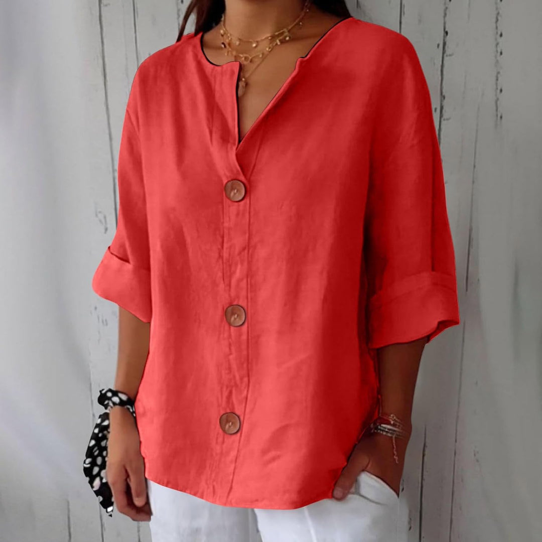 Red linen V-neck blouse with wooden buttons, relaxed fit, and three-quarter rolled sleeves.