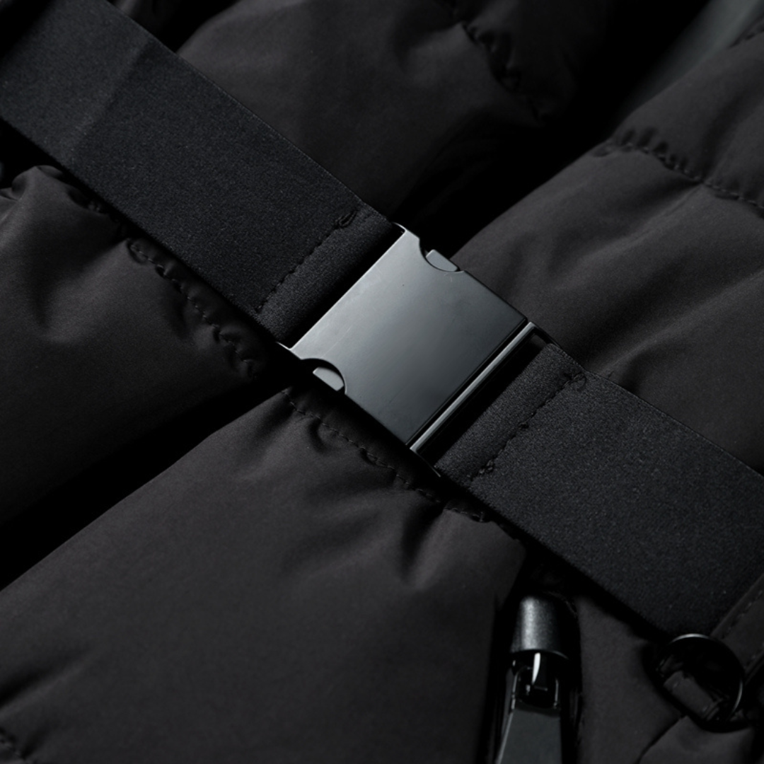 Close-up of a black quilted puffer jacket featuring a sleek, adjustable waist belt with a matching black buckle.