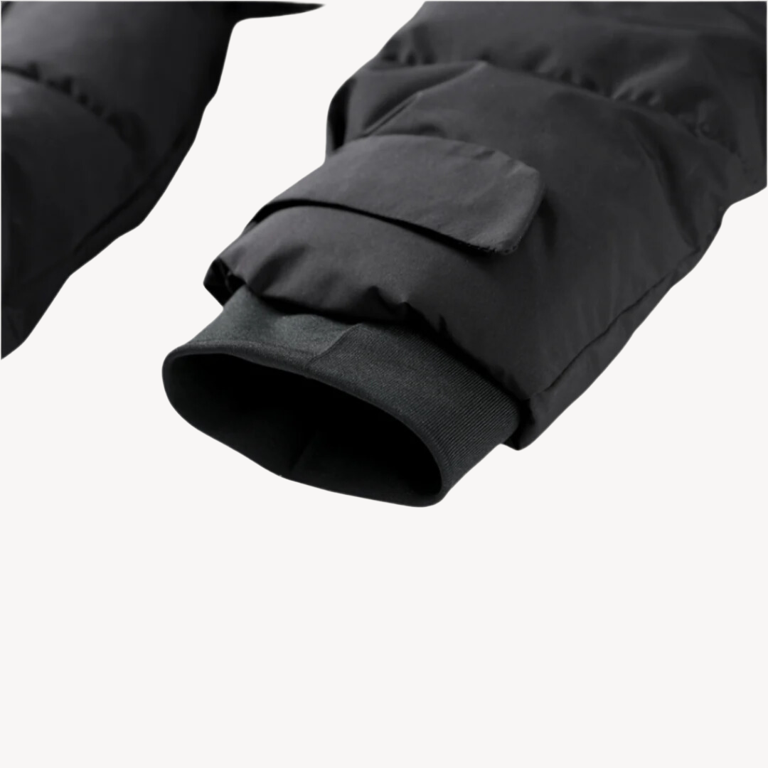 Black quilted puffer jacket sleeve featuring a ribbed inner cuff and a secure flap pocket detail.