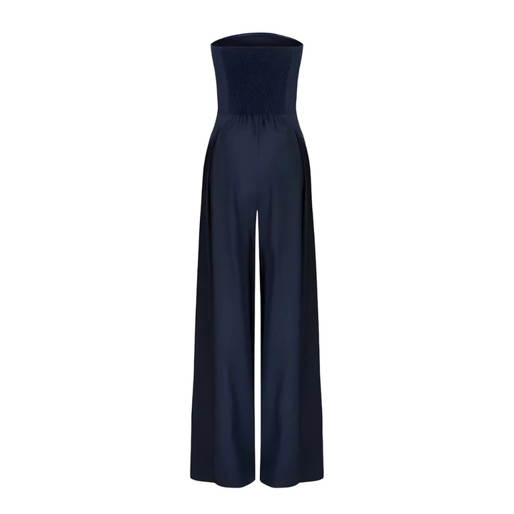 Women's navy strapless wide-leg Imogen jumpsuit with a shirred bodice and pleated front detail.