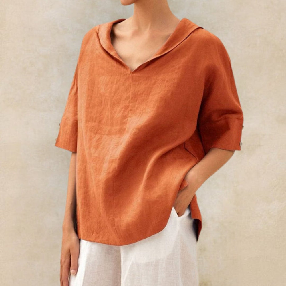 Rust orange linen-look V-neck blouse with a draped collar, half-length sleeves, and button cuff detail.