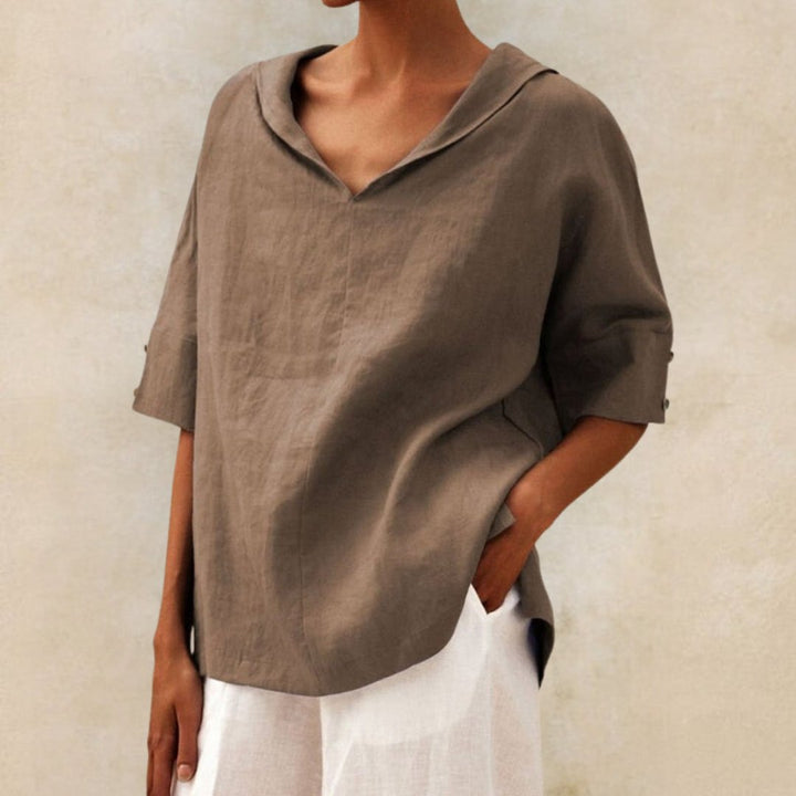 Taupe linen-look V-neck blouse with a draped collar and half-length sleeves featuring button cuffs.