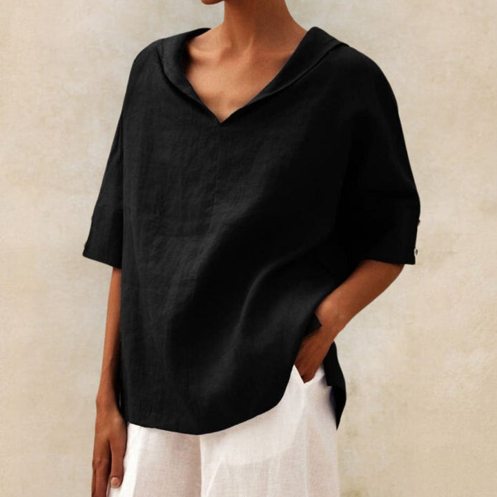 Black linen-look V-neck blouse with a draped collar and half-length sleeves featuring button cuff details.