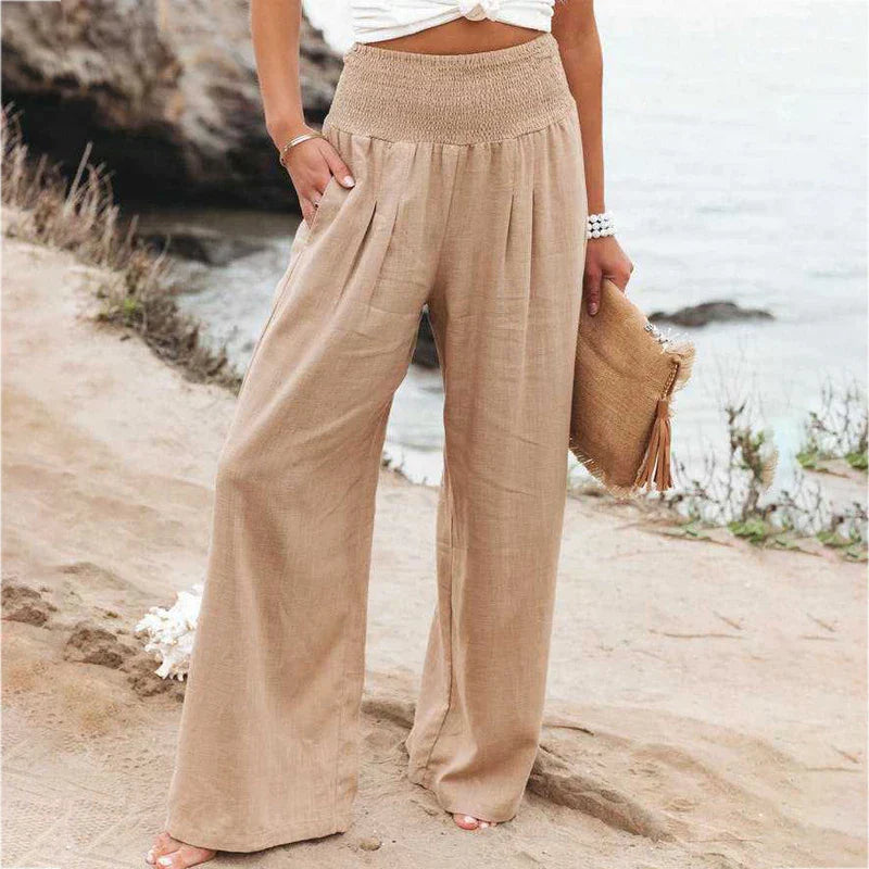 Iris Women's Linen Summer Trousers: Relaxed fit, flowing beige linen pants with a shirred elastic waistband and pockets.