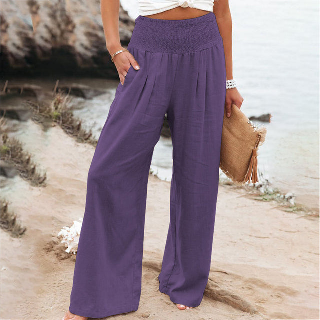 Iris women's relaxed fit purple linen summer trousers with a shirred elastic waistband and pockets.
