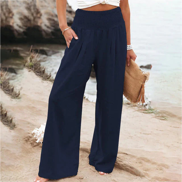 Iris Women's Navy Linen Summer Trousers with a relaxed fit, elastic waistband, and flowing fabric.