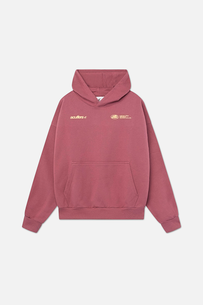 Dusty rose oversized pullover hoodie with a lined hood, kangaroo pocket, and small white logo detailing on the chest.