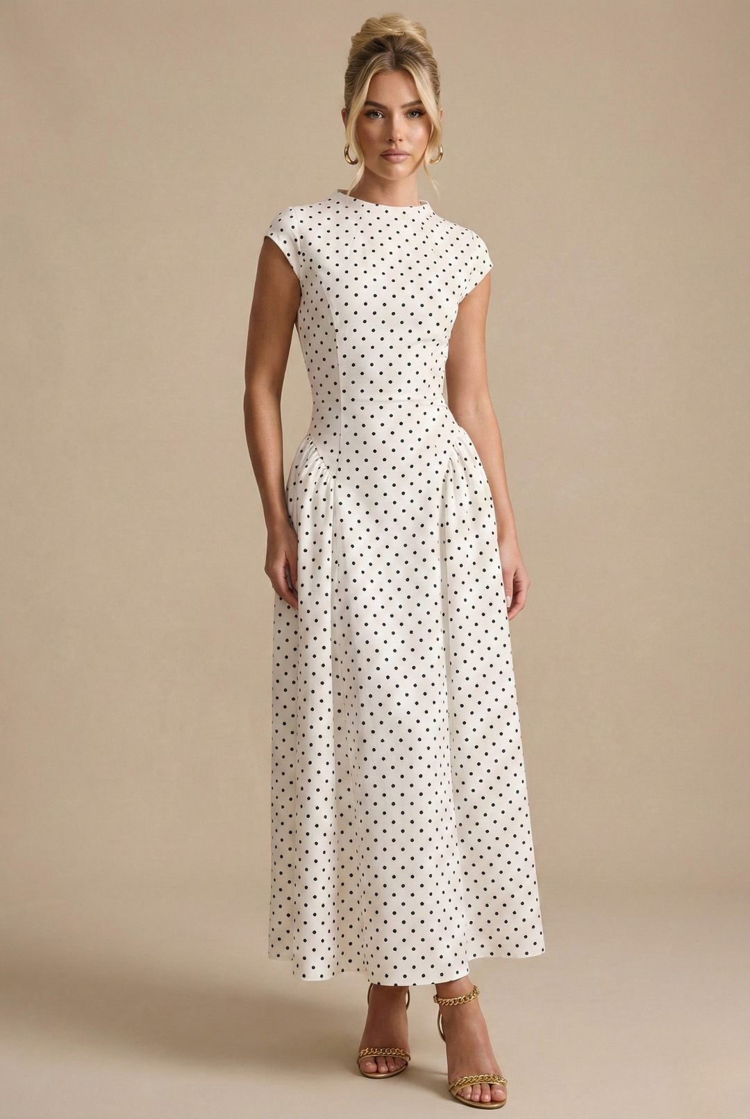 Isabelle white polka dot A-line maxi dress with a round neckline, defined waist, and elegant drape.
