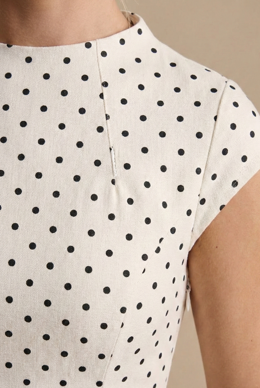 Isabelle women's sleeveless A-line maxi dress in white with a timeless black polka dot pattern.