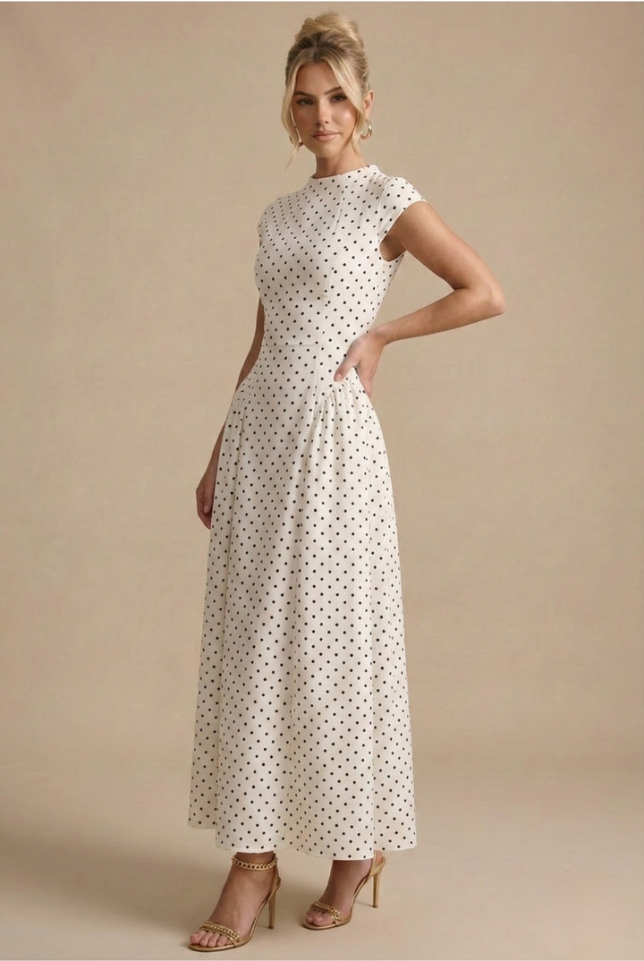 Isabelle women's white polka dot A-line maxi dress with a round neckline and defined waist.