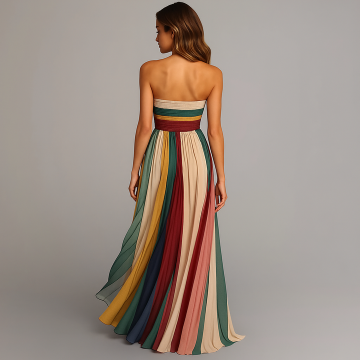 Isabelle strapless pleated maxi dress in vibrant, flowing colorful stripes.