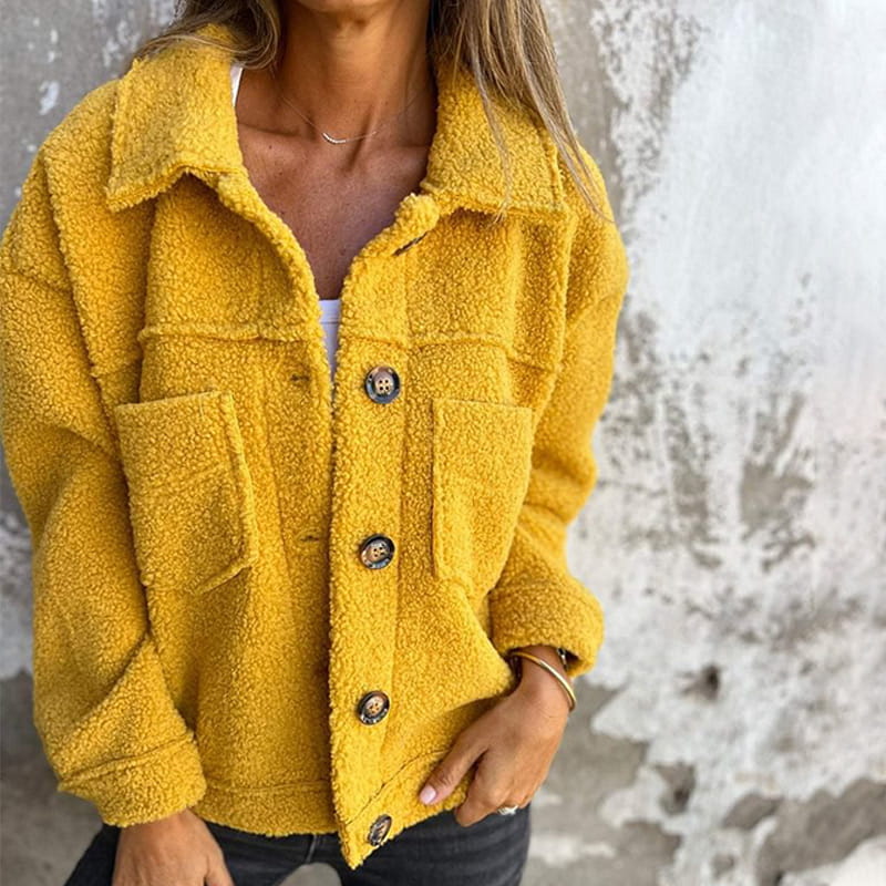 Mustard yellow teddy jacket with a spread collar, button-front closure, and two chest pockets in a relaxed fit.