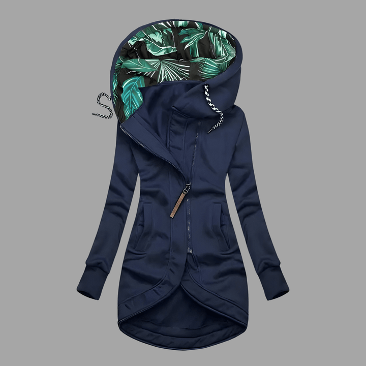 Navy blue longline hooded parka with an asymmetric zip and green tropical-print lining.