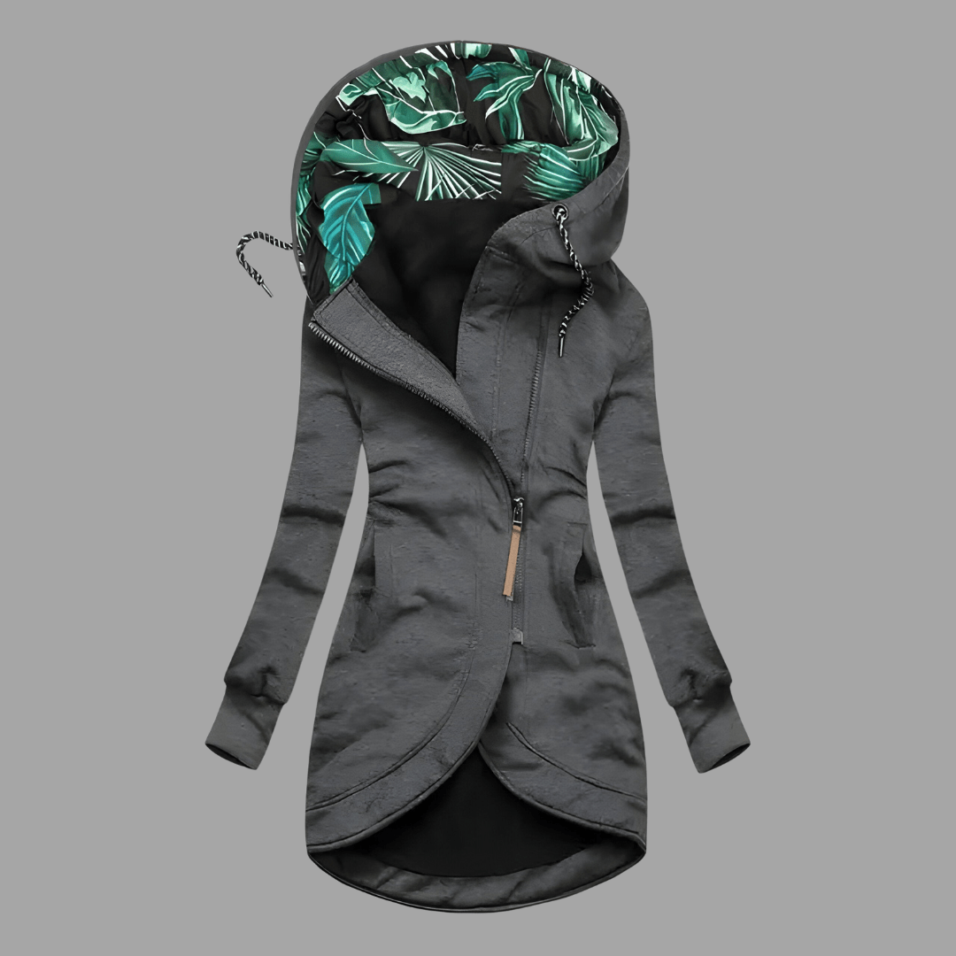 Charcoal grey longline hooded parka with an asymmetric zip and a vibrant green tropical leaf print hood lining.