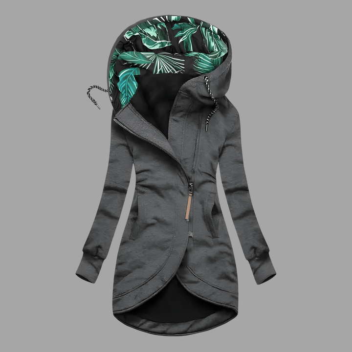 Charcoal grey longline hooded parka with an asymmetric zip and a vibrant green tropical leaf print hood lining.