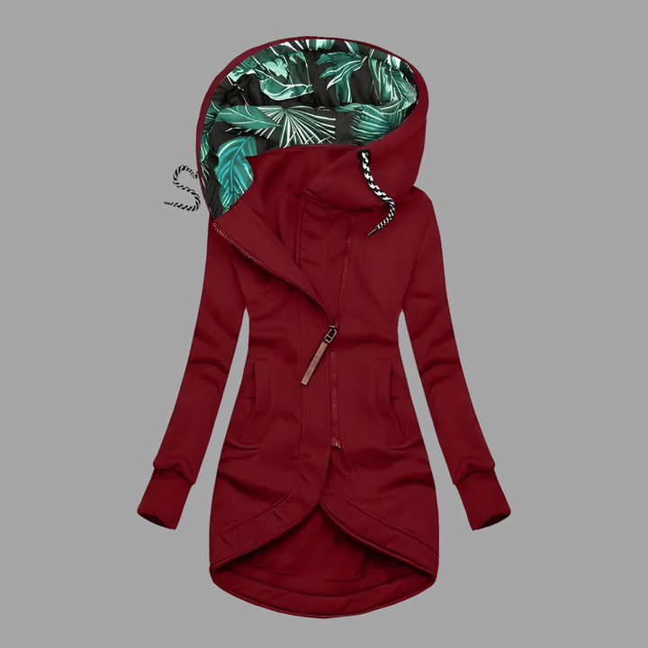 Burgundy longline hooded parka with an asymmetric zip and green tropical-print lining.