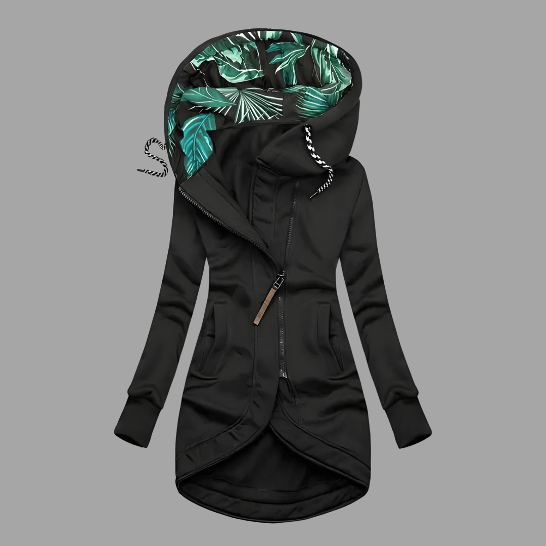 Black longline hooded parka with an asymmetric zip, front pockets, and a green tropical-print hood lining.