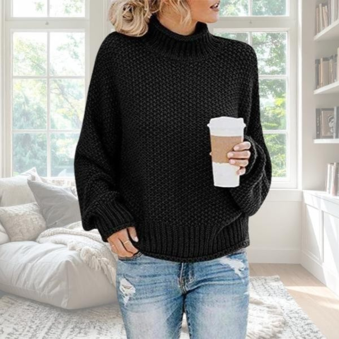 Black chunky knit turtleneck jumper with a relaxed fit, dropped sleeves, and ribbed trim, styled with blue jeans.