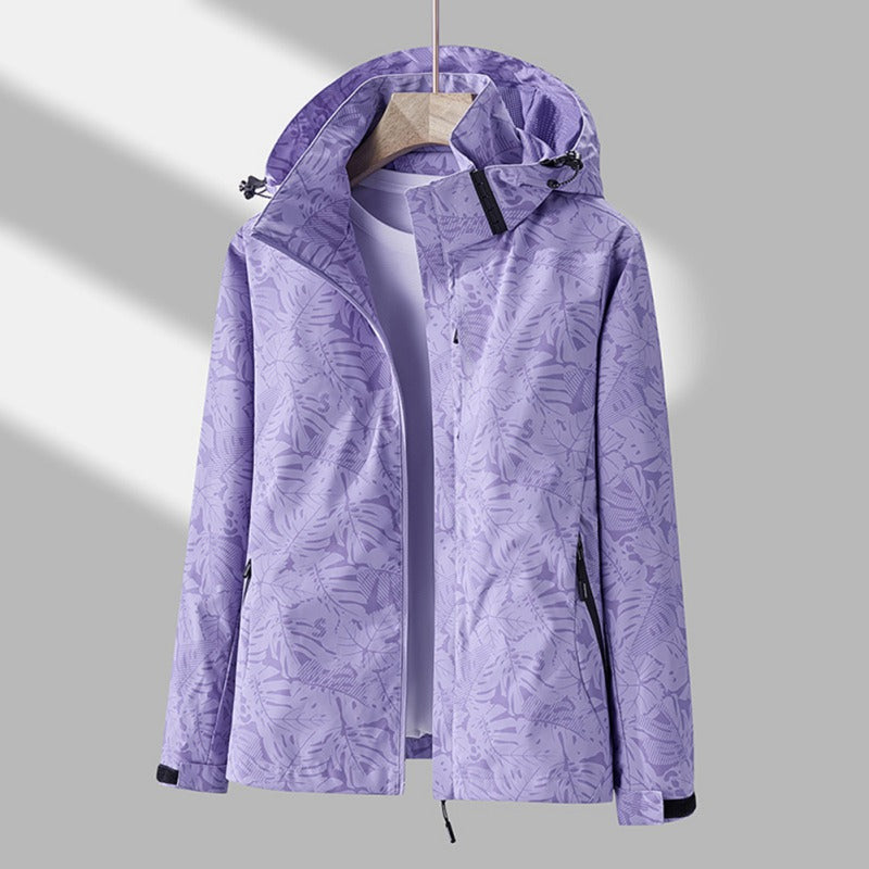 Purple waterproof hooded jacket featuring a tropical leaf print, full-length zip, and adjustable hood.