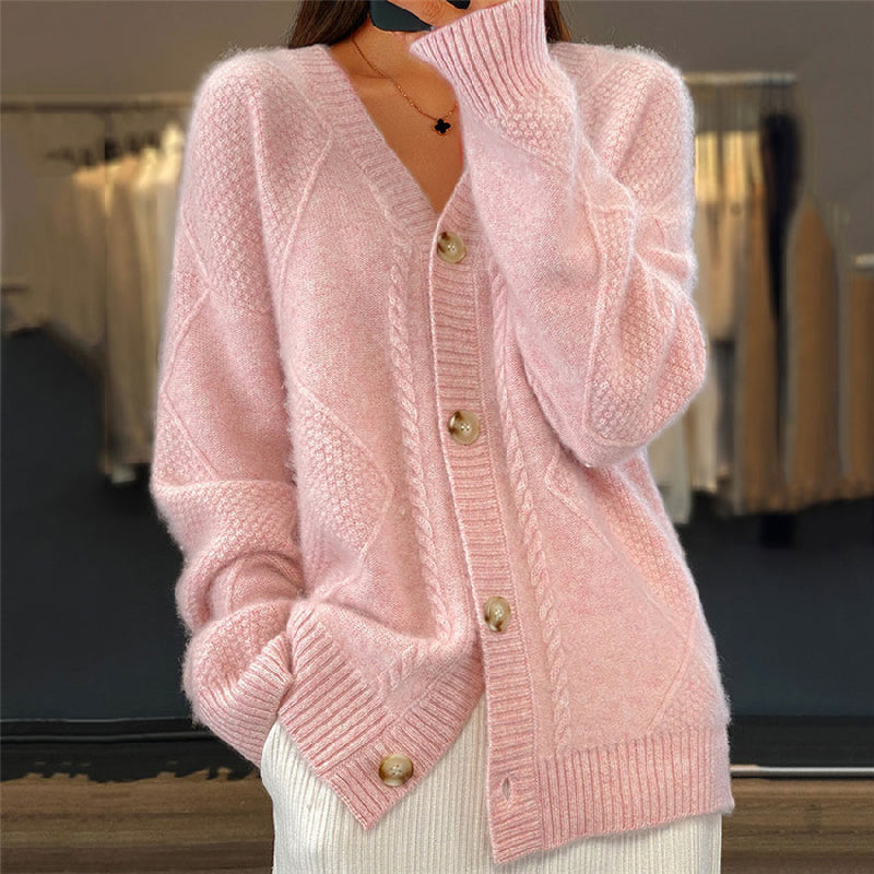 Soft pink wool cable knit cardigan with a V-neck, button-up front, and textured diamond-pattern weave.