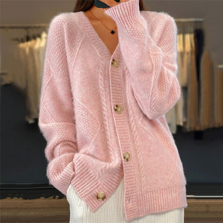 Soft pink wool cable knit cardigan with a V-neck, button-up front, and textured diamond-pattern weave.
