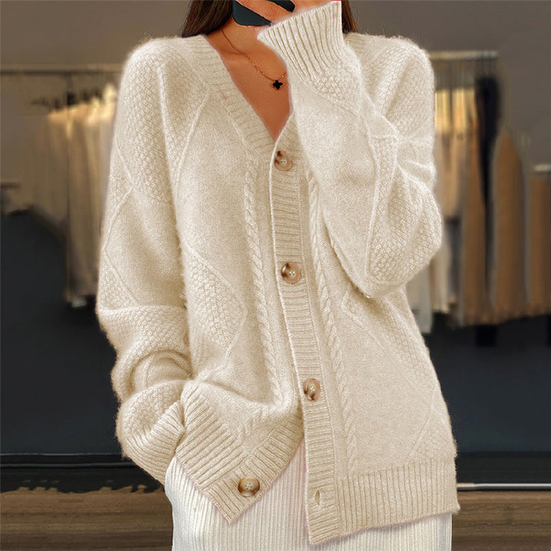 Beige cable knit wool cardigan with a V-neck, button-front closure, and ribbed cuffs in a relaxed, textured fit.
