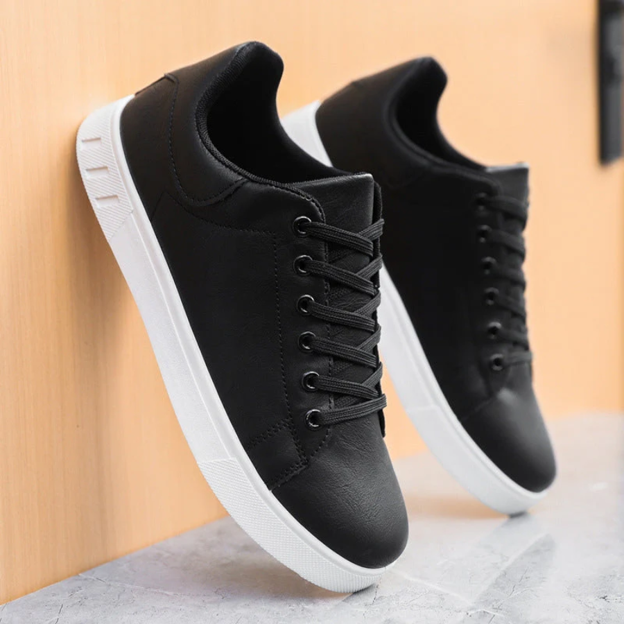 Men's black lace-up casual sneakers featuring a sleek low-profile design and a crisp white rubber sole.