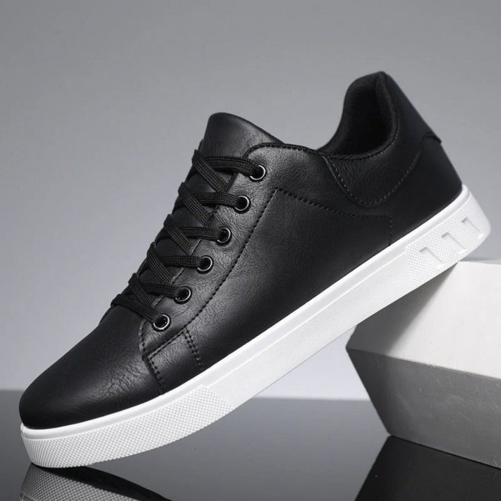 Men's black lace-up casual sneaker with a sleek low-profile design and a crisp white rubber sole.