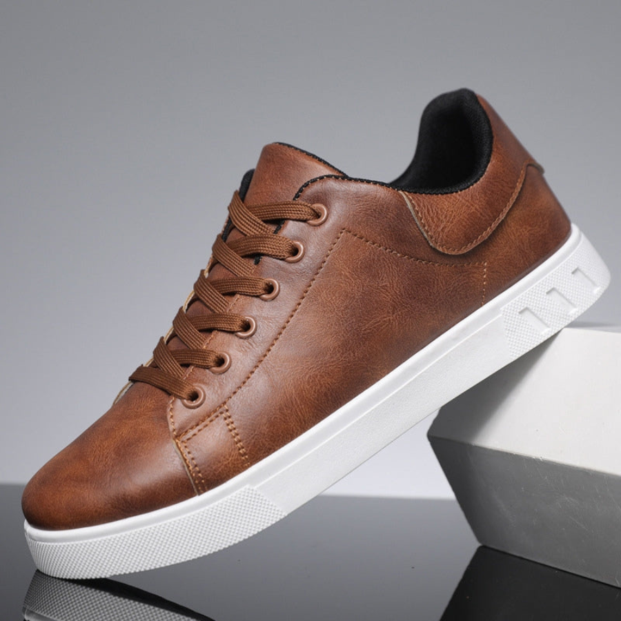 Brown leather lace-up casual sneakers with a sleek low-profile design and a thick, textured white rubber sole.